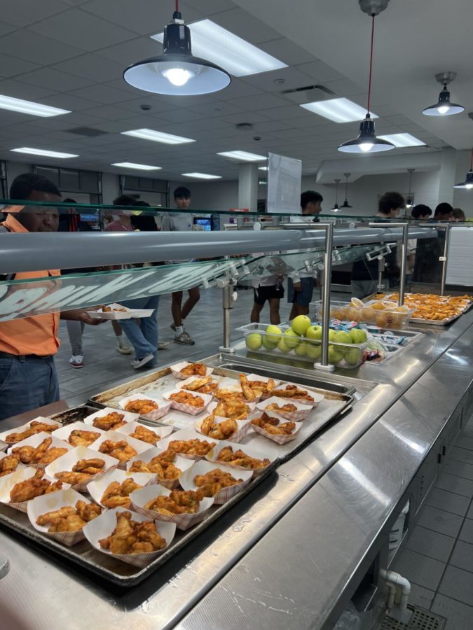 The lunch line serves chicken wings to students (photo by Nate Shull)