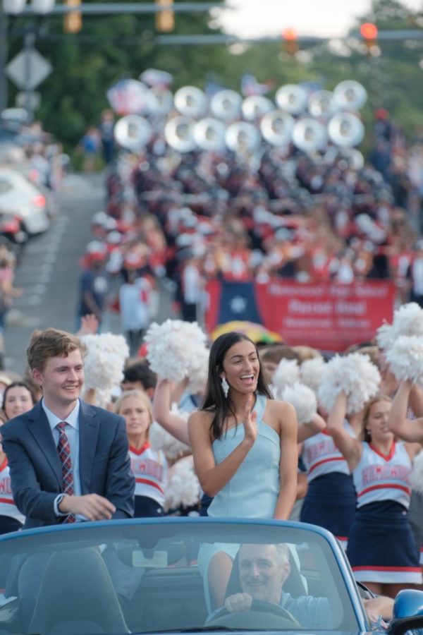 Maddie Massie (right) and Will Andress (left) waving to onlookers during the 2022 Homecoming parade (photo by Blake Pearson)