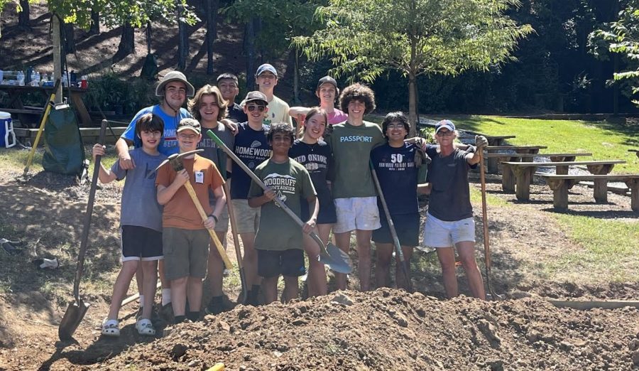 Volunteers posing amidst dirt for the rain garden (photo by Christine Nickson).