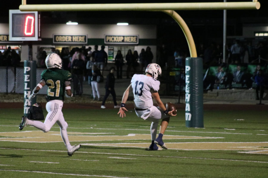 Quarterback Woods Ray (#13) flips football into the endzone, after rushing for a 55 yard touchdown vs Pelham on 10/14/22. (Photo by Henry Sklar)
