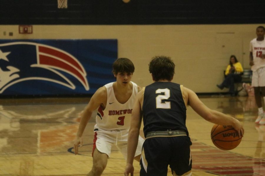 Senior Carson Cole locks up Briarwood guard on defense (photo by Russell Dearing)
