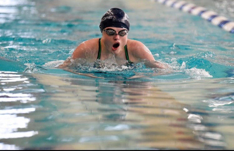 Brandrup pushes to the finish during an indoor swim meet (photo by Adele Brandrup).