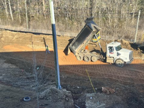 Construction crews lay dirt as a foundation for an extension to Homewood High Schools north parking lot bordering Shades Creek. (Photo by Julian Kersh)