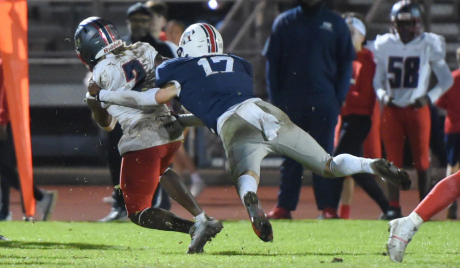 Samford commit Clay Burdeshaw tackles a Pike Road running back during Homewoods playoff game vs Pike Road.