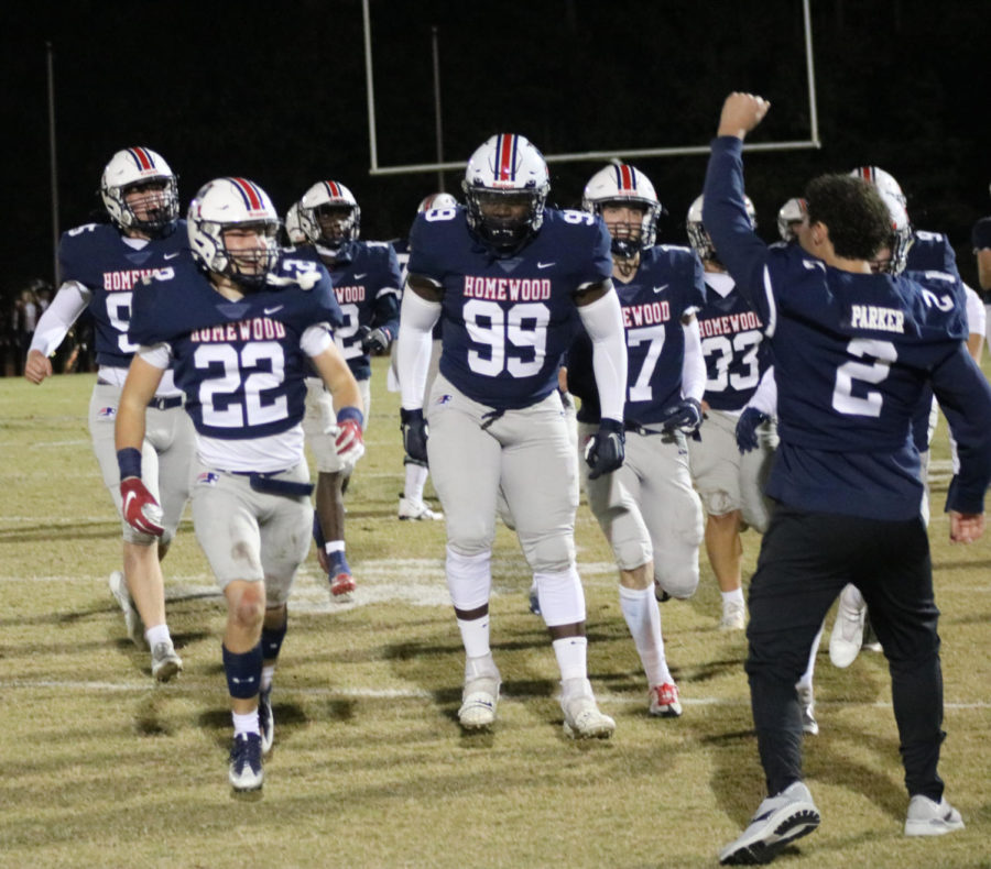 No. 22 Parker Sansing celebrates with his teammates on the sideline after forcing an interception.  