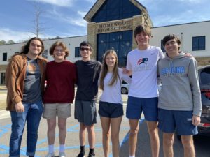 This year's National Merit finalists pose outside the entrance to HHS (photo by Michael Keim).