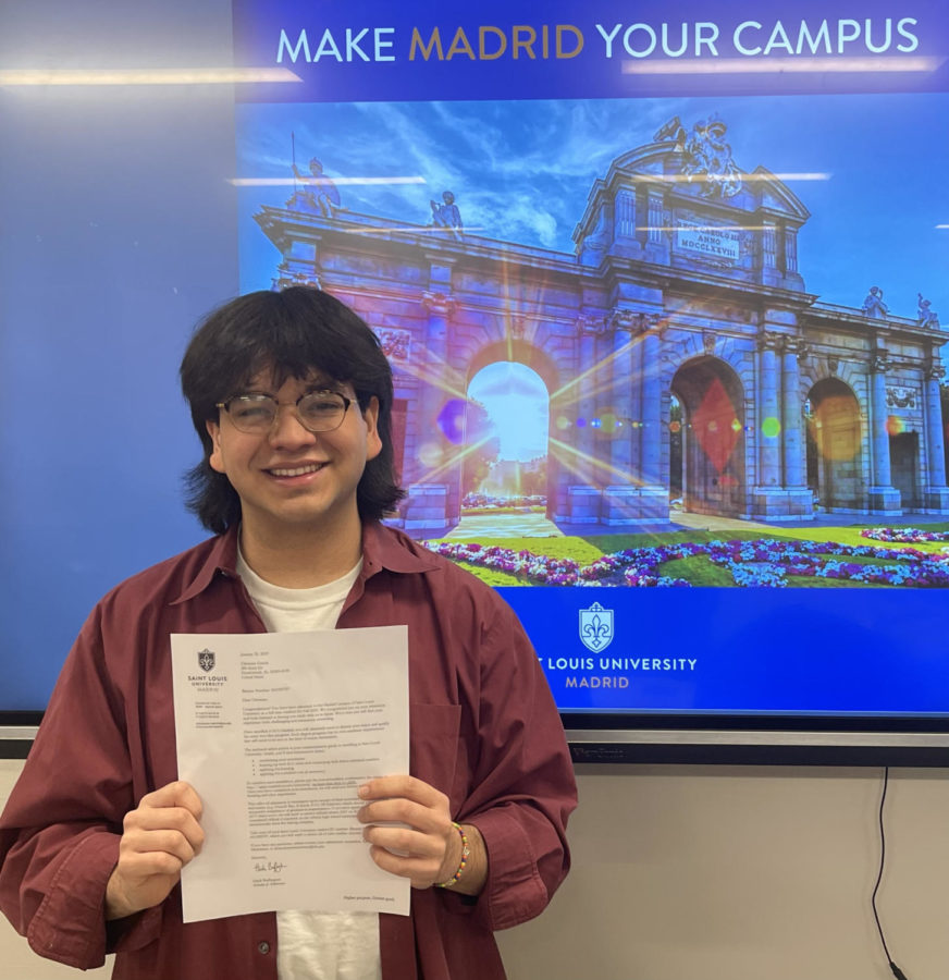 Christian Garcia holding his acceptance letter to Saint Louis University Madrid (Photo by Charlotte Lee).