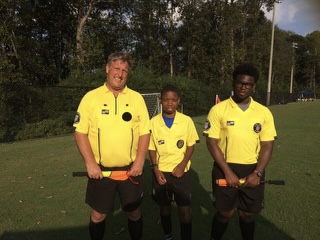 Jimmy Troxell (Left) stands with his officiating crew before a soccer match.  