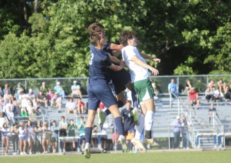 Multiple players clash for a header (photo by Russell Dearing).