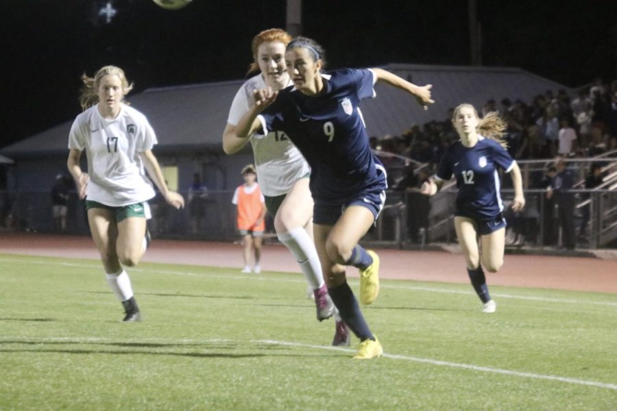 Senior Maddie Massie chases down a loose ball in Mountain Brooks penalty area. (photo by Russell Dearing). 