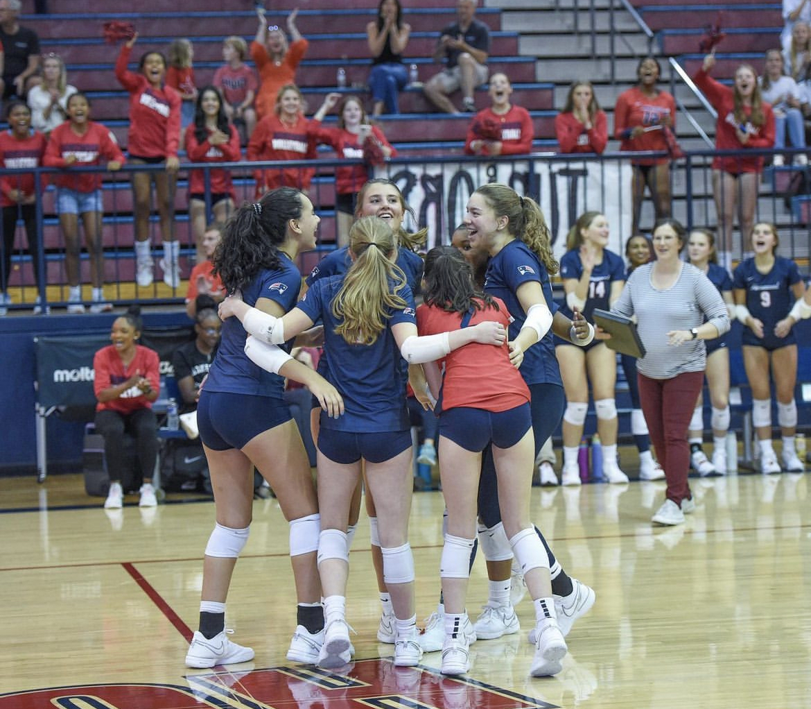 The+varsity+volleyball+team+celebrates+after+scoring+during+Tuesdays+in-school+match.+The+Patriots+eventually+fell+to+the+Chelsea+Hornets+three+sets+to+one.+%28Photo+contributed+by+Homewood+Athletics+Instagram%29