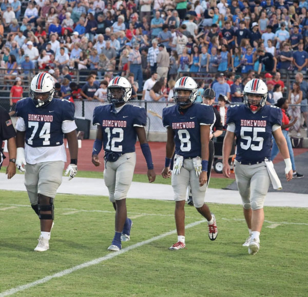 On the far left, Jaxon brooks and next to him, Talton Thomas walk out as the Homewood Patriot captains as they prepare to face Helena in week 3. Photo taken by Wilson Riley.