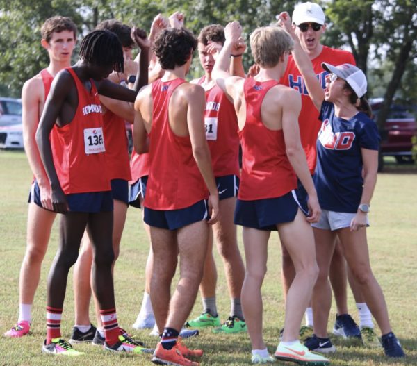 Boys cross country team gathers in their pre-race huddle.