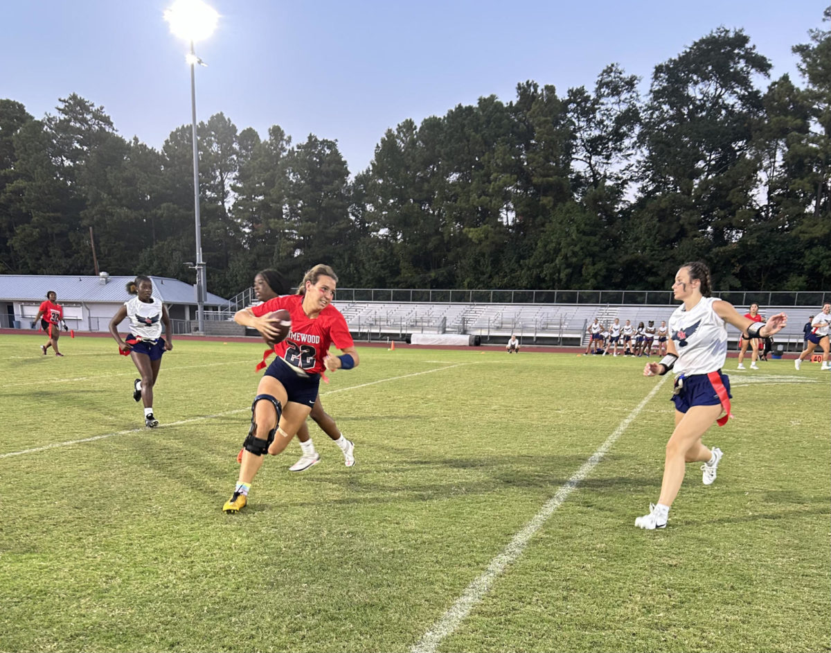 Sadie Busbee runs the ball for the Patriots in the second half.