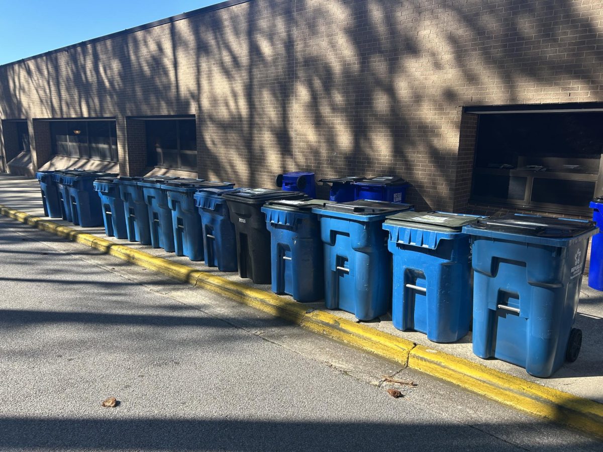 Empty recycling bins lining the sidewalk at the back of HHS.