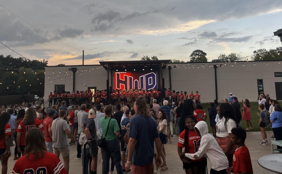 Homewood's varsity football team can be seen on stage as Coach Berguson introduces the team.