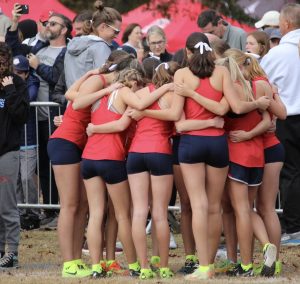 The girls' cross-country team huddles before the state final Nov. 11, 2023.