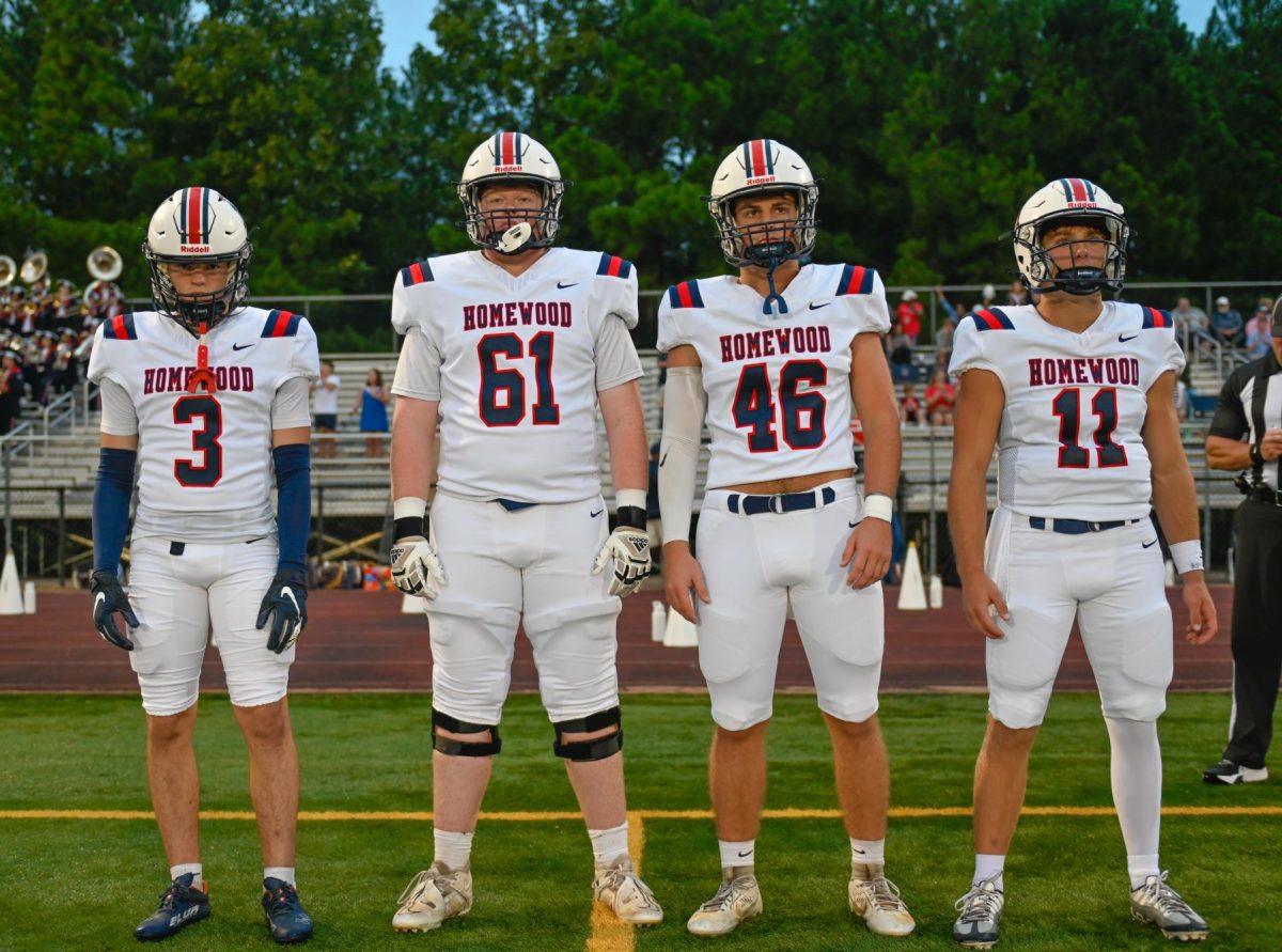 (From left to right) John Griffin, Walker Williams, Ford Hawkins, and Will Myers prepare to walk out as team captains against Mortimer Jordan. The Patriots are soaring, notching a 3-0 start to begin the 2024 season.