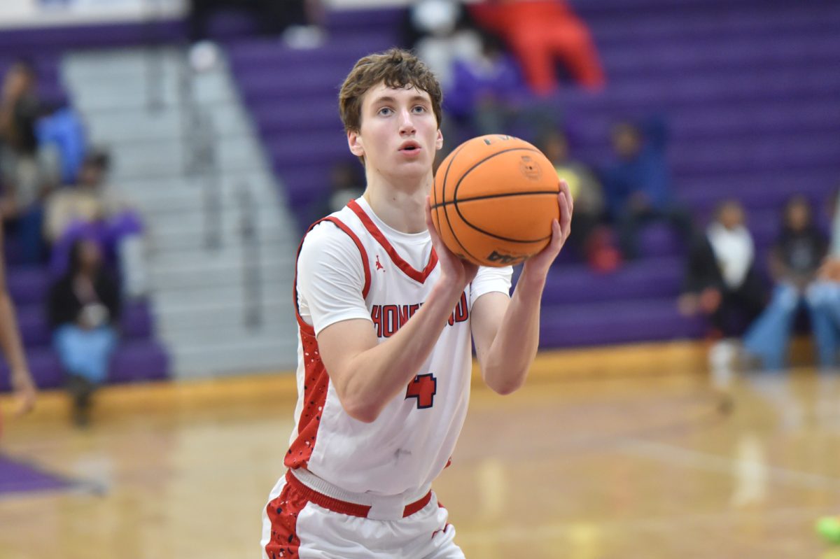 Latham Binkley shoots basket in game against Minor.