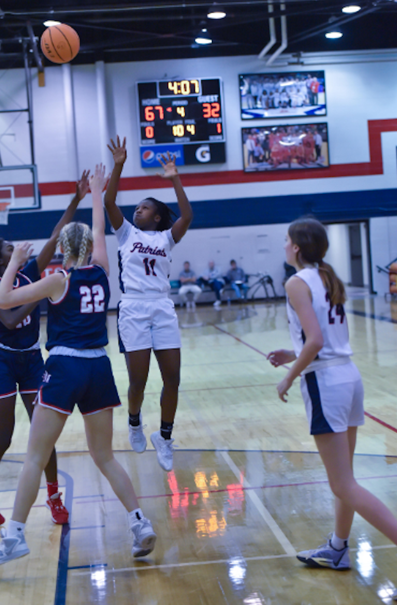 Savannah McDonald attempts to score against Oak Mountain last season. The patriots ended this game with a win of 71 to 32.