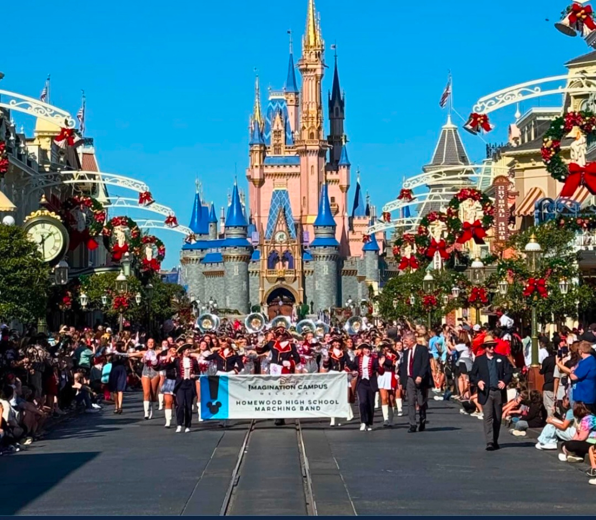 The Homewood Patriot Marching Band marching at Magic Kingdom in front of Cinderella's castle. 