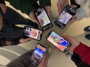 HHS students scroll their TikTok for-you page before the Jan. 19 ban.