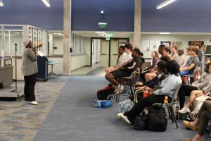Salah Green recites poetry to students in the library during fifth period.