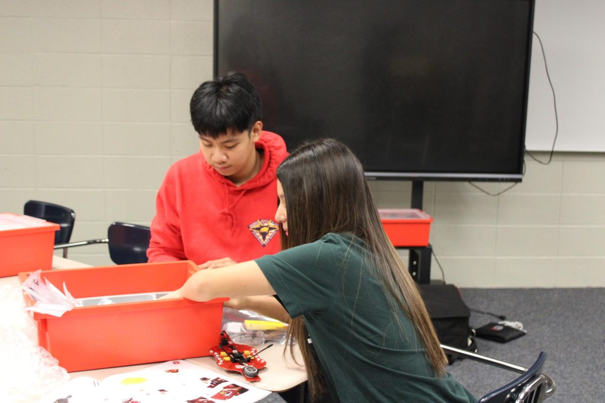 JROTC members Rhenz Tagulao and Pierina Cubas Zucchetti put together quadcopters in the glassroom. The new program equips students with STEM skills needed in several industries ranging from agriculture to media.