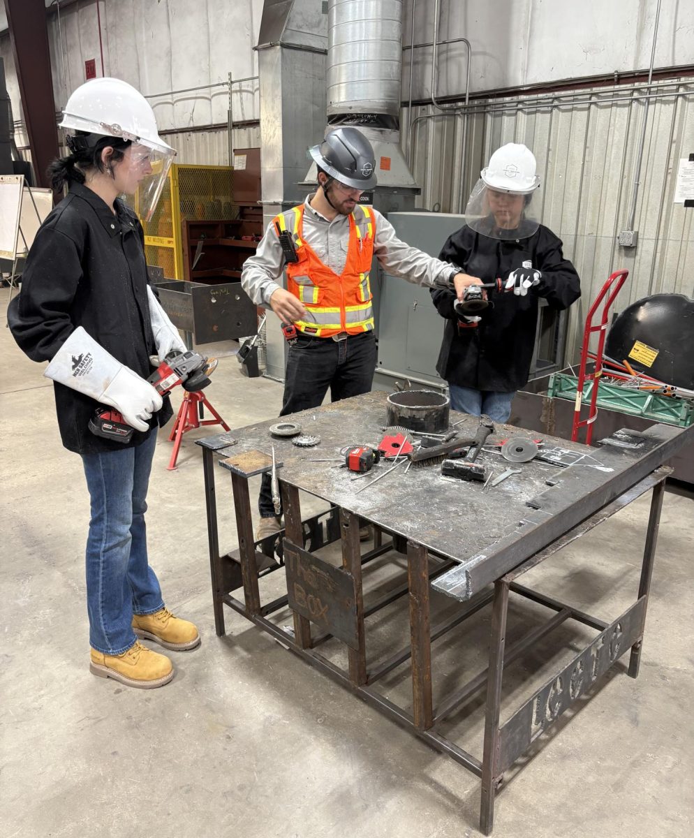 Evan Lyons (left) and Emily Villanueva Garcia (right) learn how to operate a grinder from the welding instructor at Craft. Seasoned industry professionals train students at Craft for high-demand specialties ranging from commercial construction to HVAC and mechanical systems. 