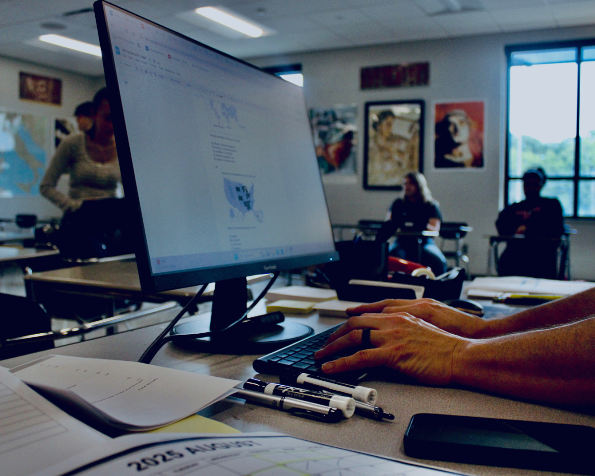 Latin teacher Jacob Linder prepares a test for his students. During the 25-26 school year, homework and classwork do not mathematically impact students' grades in PowerSchool.