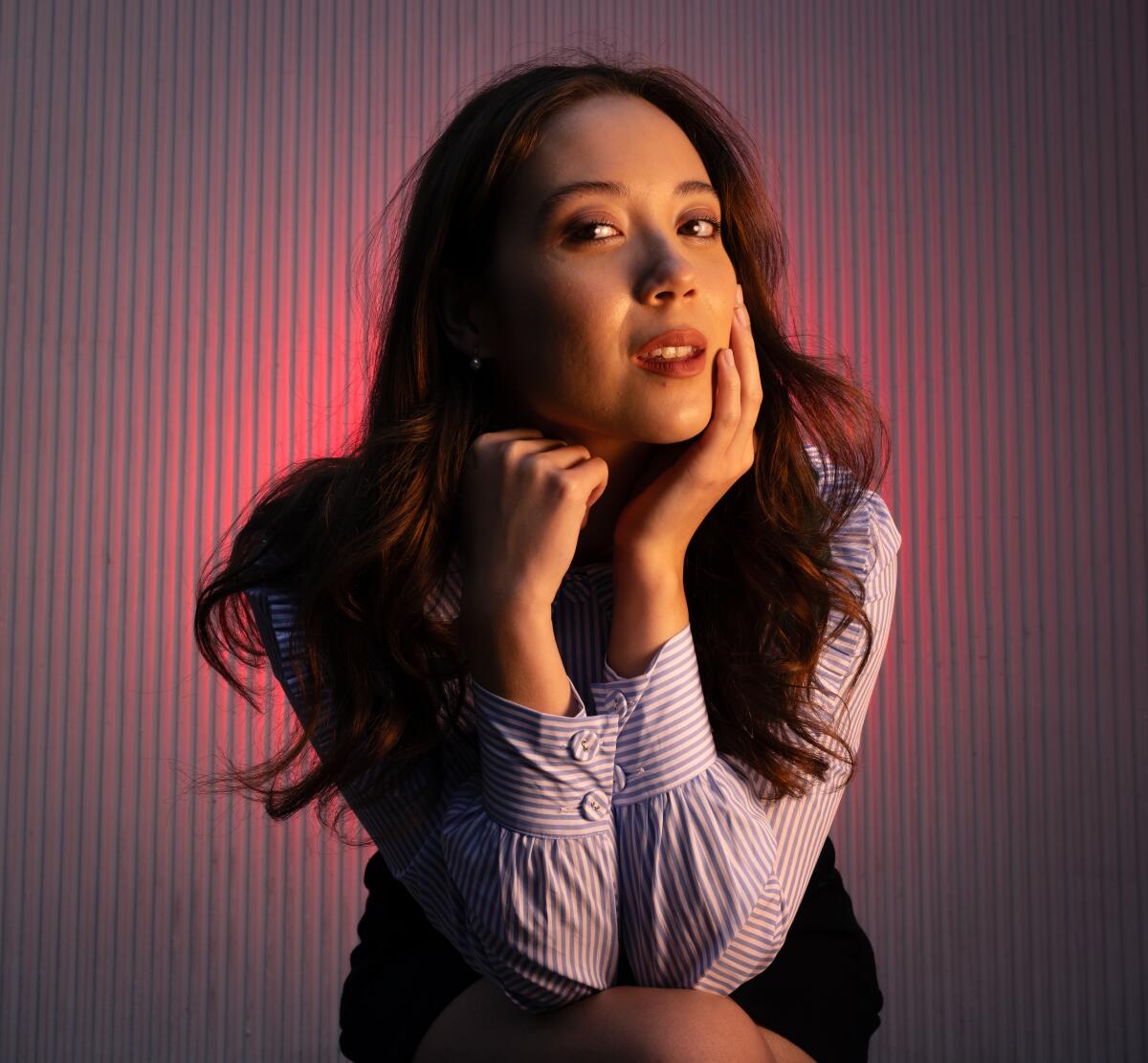 Singer-songwriter Laufey poses for a promo of her concert movie “Laufey’s A Night at the Symphony: Hollywood Bowl.” Her album "A Matter of Time" debuted at No. 1 on four Billboard album charts. (Christina House / The Los Angeles Times)