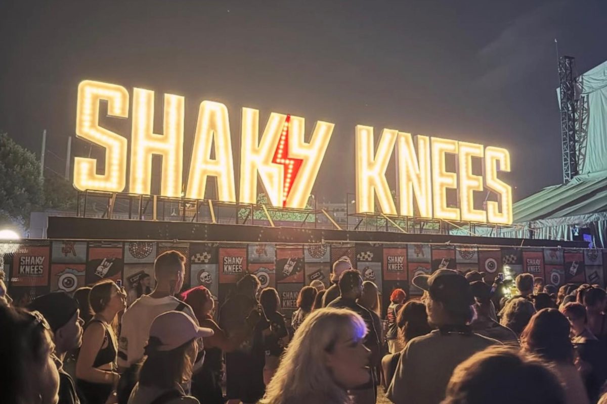An LED "Shaky Knees" logo illuminates a crowd wandering between music stages. Figures estimate nearly 40,000 attended the festival, with all of the tickets for  Saturday being sold out.
