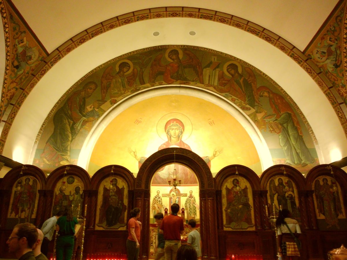 Visitors admire the inside of Holy Cross Holy Trinity. The Greek Byzantine architecture includes elements of domes and arches, symbolizing the connection between heaven and earth.