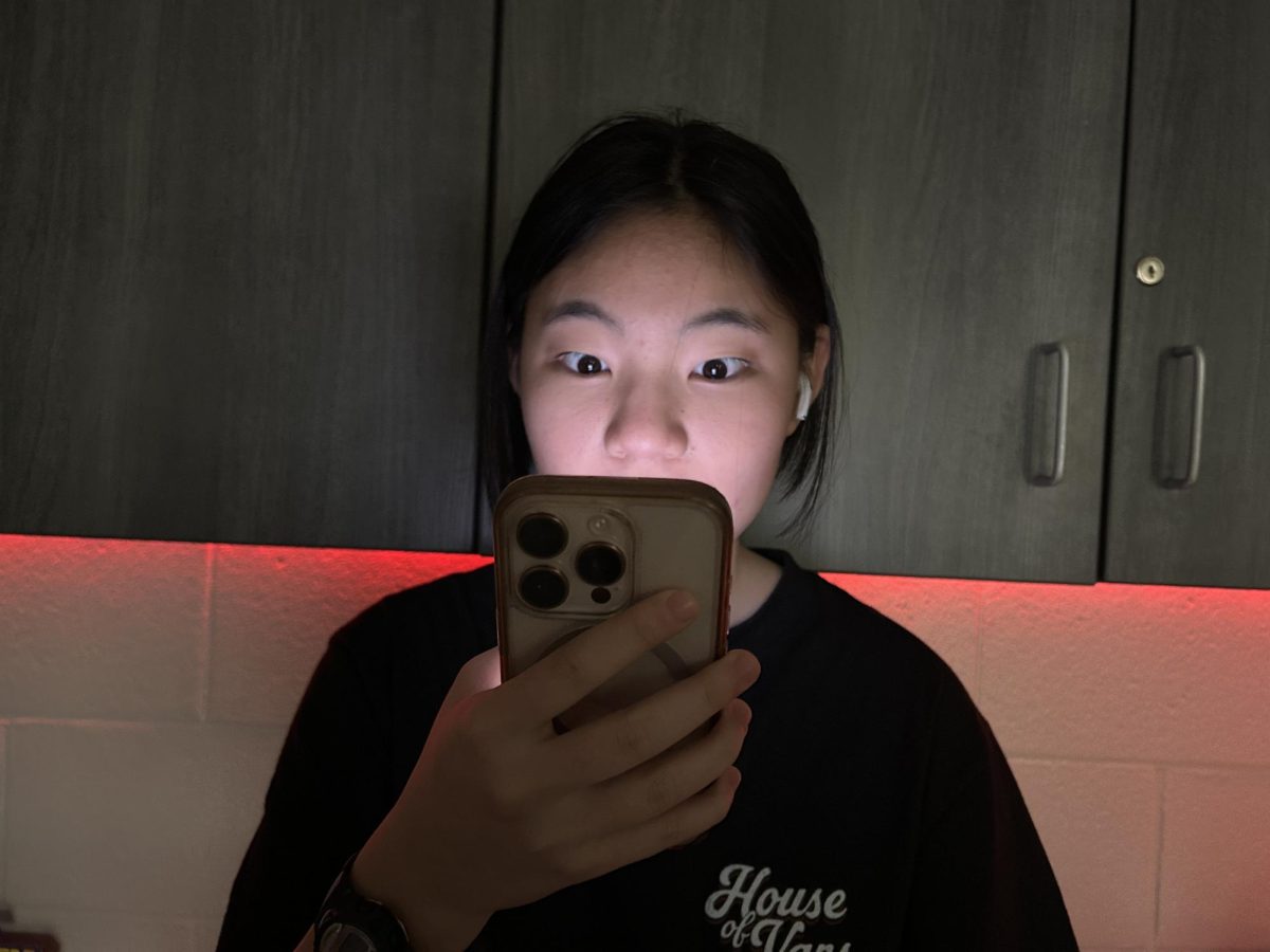 A young girl reacts to disturbing content on her phone. A study from the Youth Endowment Fund, which surveyed 10,000 teens aged 13-17 years old, revealed that 70% of teens have experienced real-life violence online.