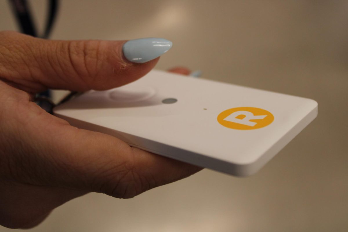 The button on the white card activates emergency alerts that every teacher is required to keep in an easily accessible location. Most faculty members keep the card on their lanyard or on their desk.