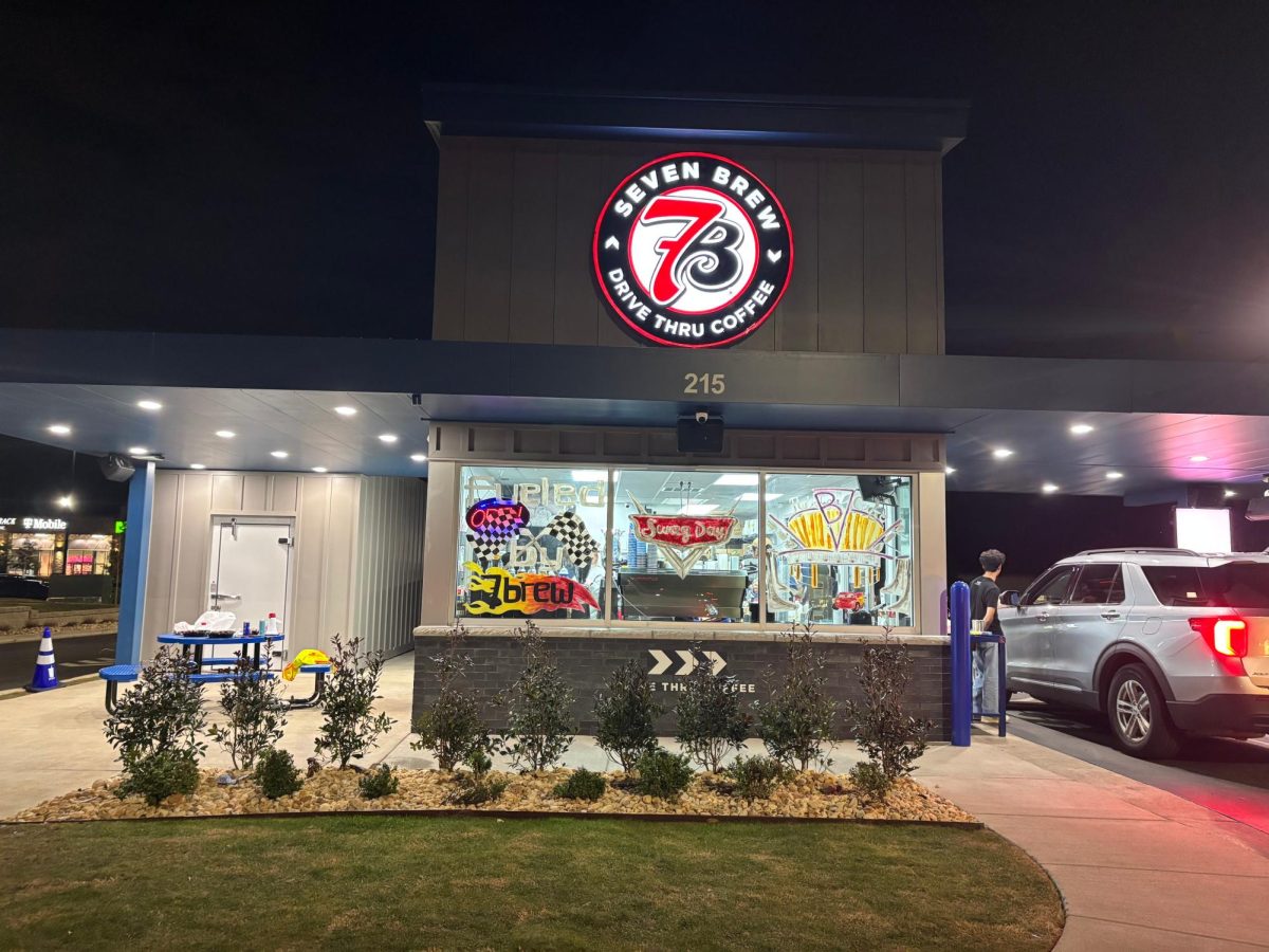 7 Brew employees serve customers drinks through the open drive-thru window. The new Wildwood location officially opened Jan. 19 after two weeks of promotions.