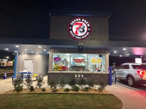 7 Brew employees serve customers drinks through the open drive-thru window. The new Wildwood location officially opened Jan. 19 after two weeks of promotions.