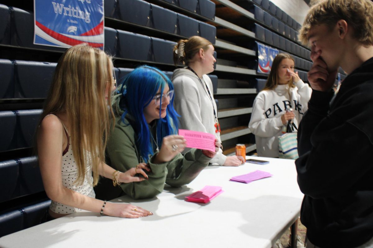 Juniors Taylor Rubens and Harper Adams pitch Creative Writing to a prospective classmate. Students experienced a range of elective offerings from world languages to career tech courses.