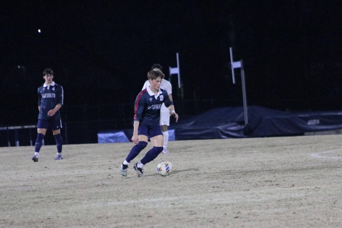 Junior captain Andy Platt dribbles the ball during a game against Calera. Homewood tied the game 1-1.