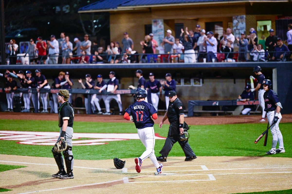 Senior captain, Levi Nickoli, rounds the plate to score a run in a game against Cullman. Homewood won the game 12-7