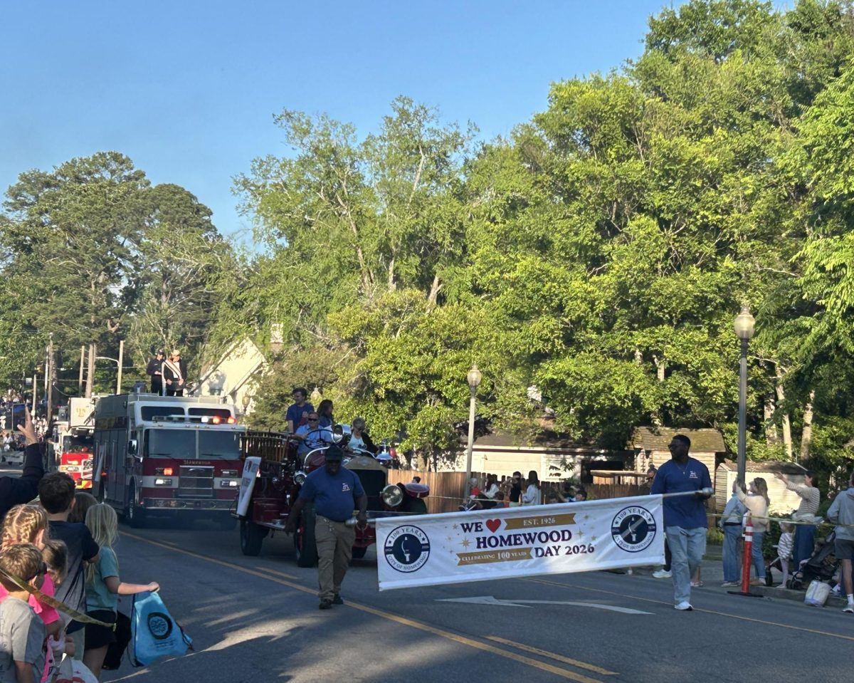 Homewood Parks and Rec staff wave to onlookers at the start of the We Love Homewood Day parade. The parade began at the Homewood Public Library and featured various local law enforcement, political candidates and special interest groups.